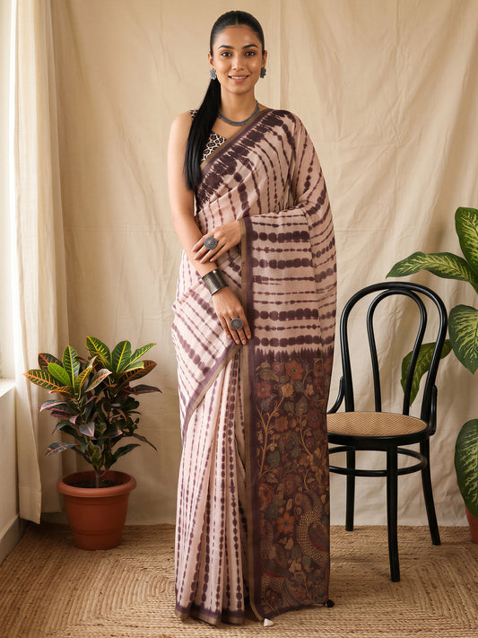 Woman wearing peach cotton blend saree with tie-and-dye resist pattern and peach blouse