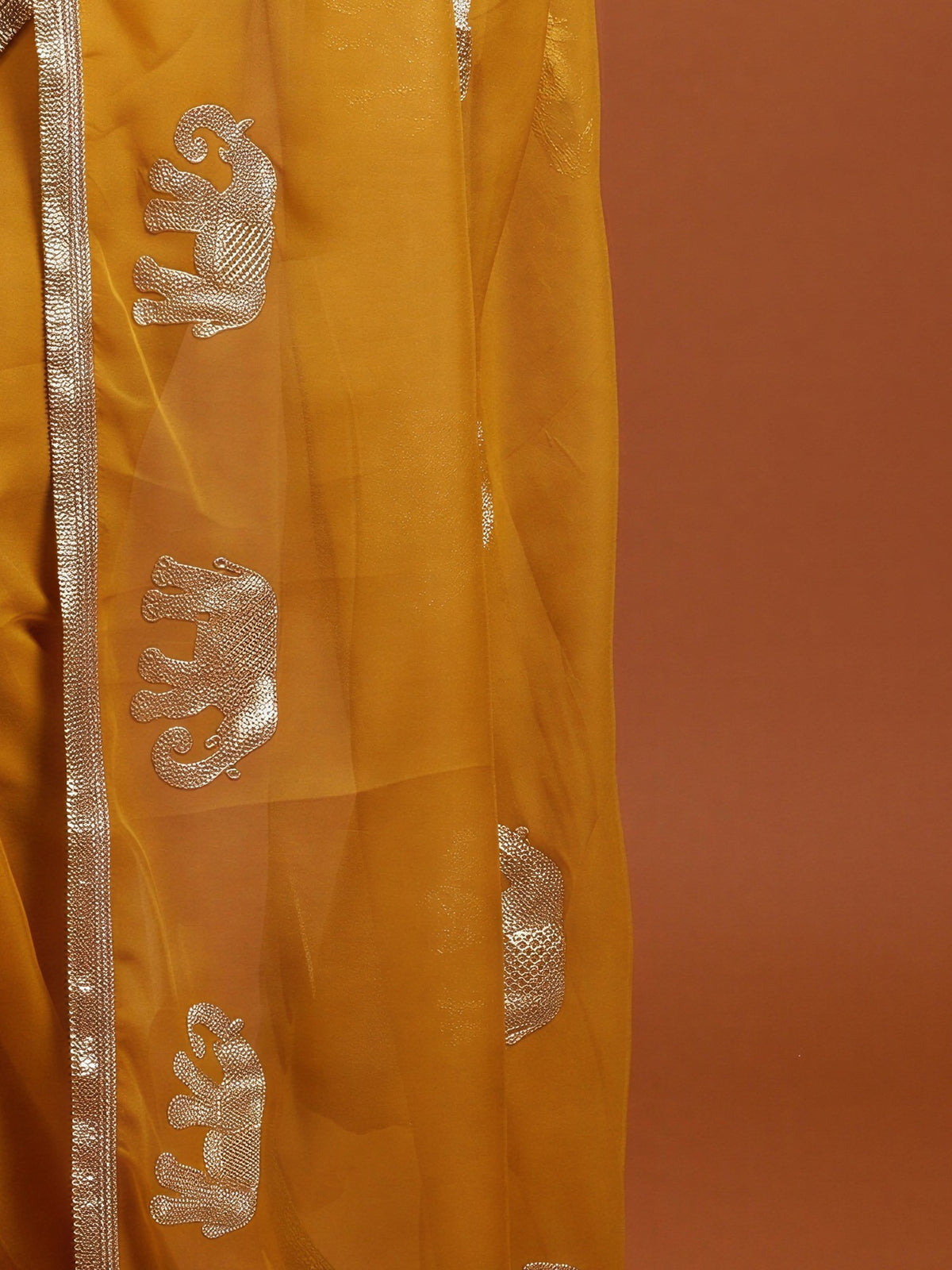 Pallu detail of mustard georgette saree showing embroidered motif work and embellished border