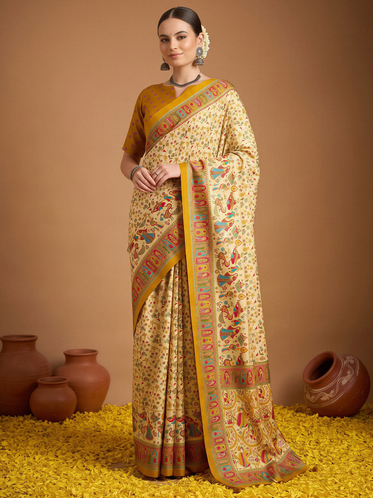 Woman wearing cream silk blend saree with metallic foil print work and mustard blouse