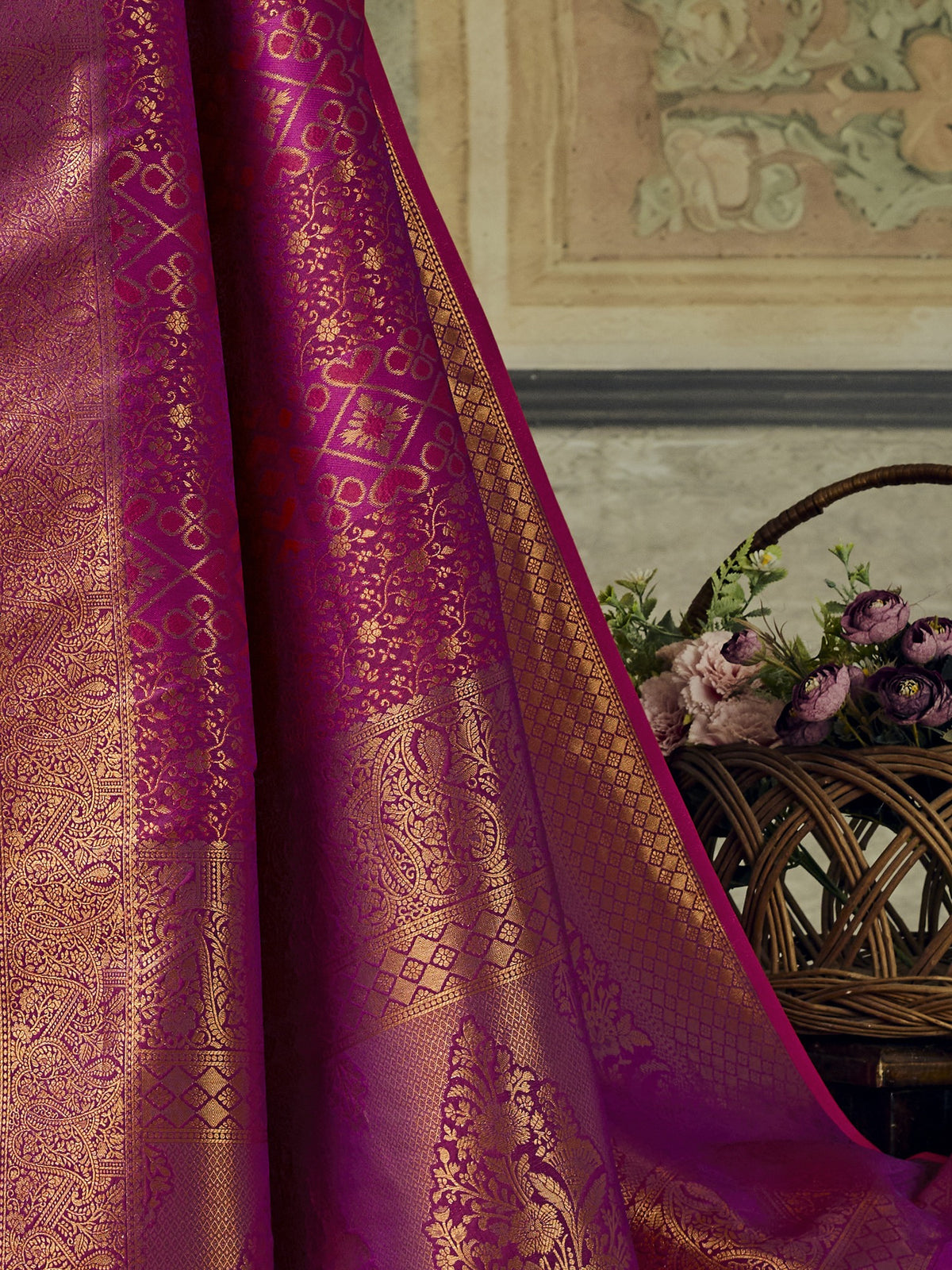Pallu detail of magenta pure silk saree showing woven motif design and zari border