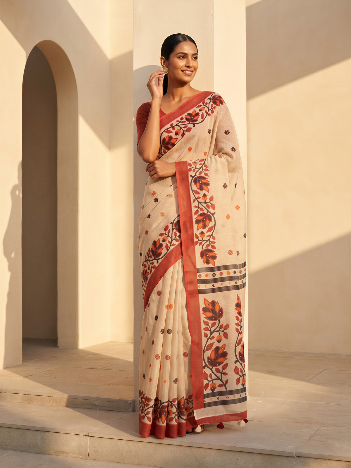 Woman wearing beige linen blend saree with all-over floral design and rust blouse