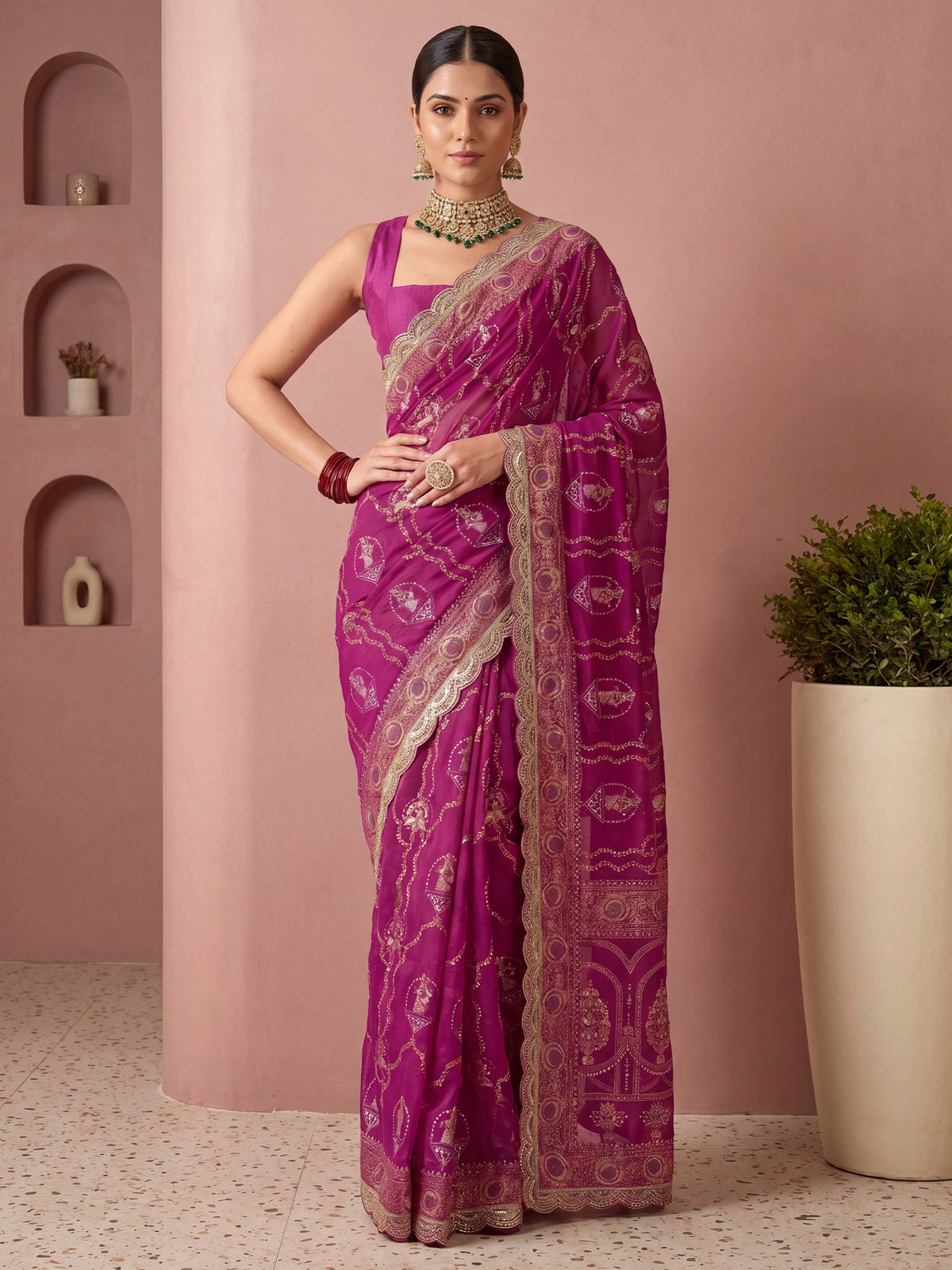 Woman wearing pink vichitra silk saree with metallic foil print work and pink blouse