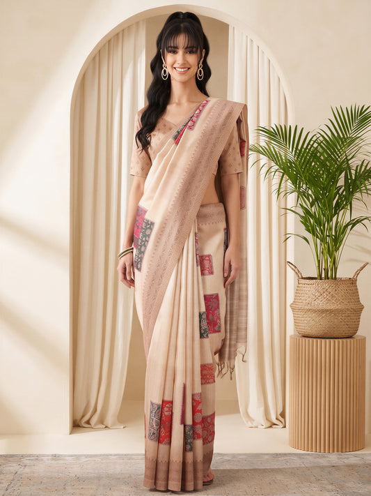 Woman wearing beige cotton silk saree with traditional indian motif work and beige blouse
