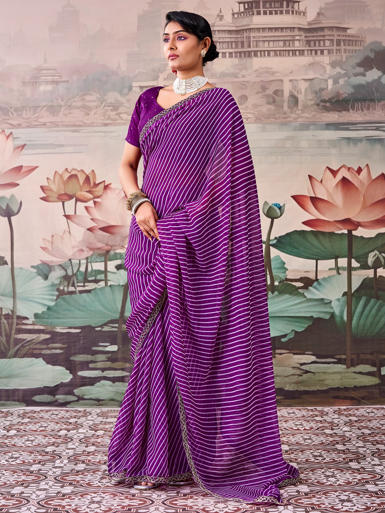 Woman wearing purple georgette saree with striped pattern design and purple blouse