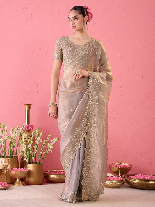 Woman wearing metallic satin ready to wear saree with ornamented surface design and metallic blouse