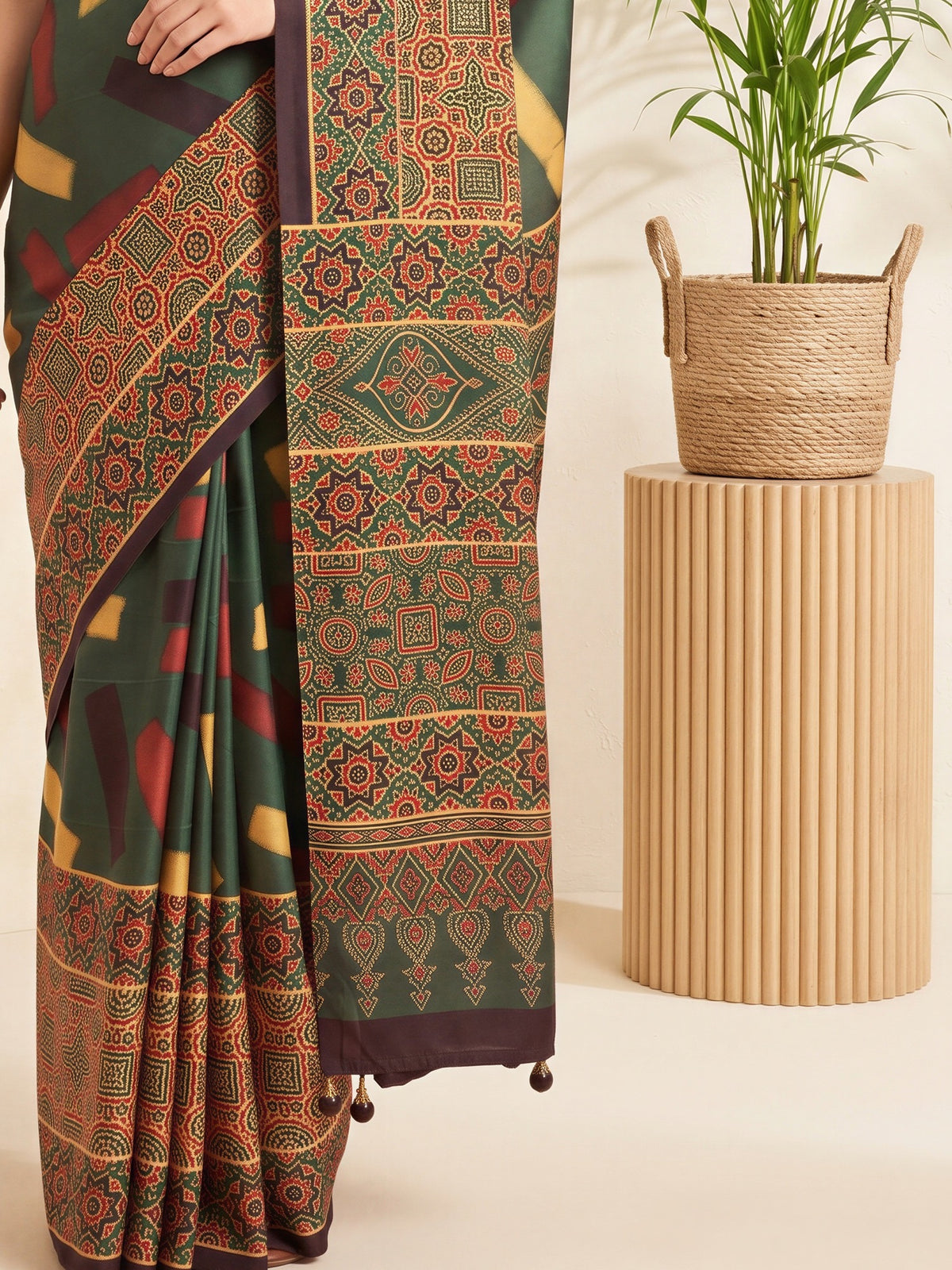 Pallu detail of green silk blend saree showing traditional indian motif work and printed border