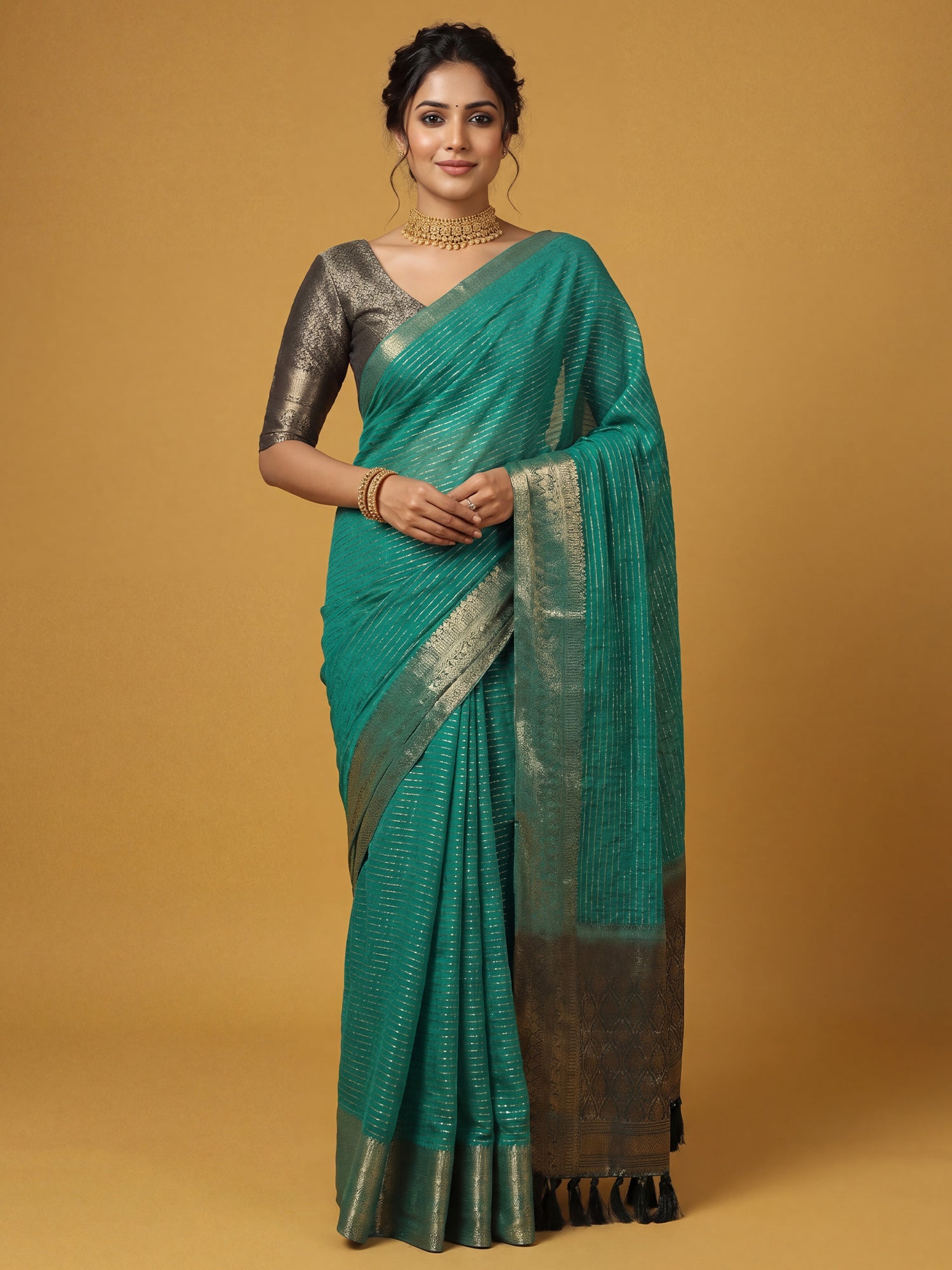 Woman wearing teal green chiffon saree with striped pattern design and dark green blouse