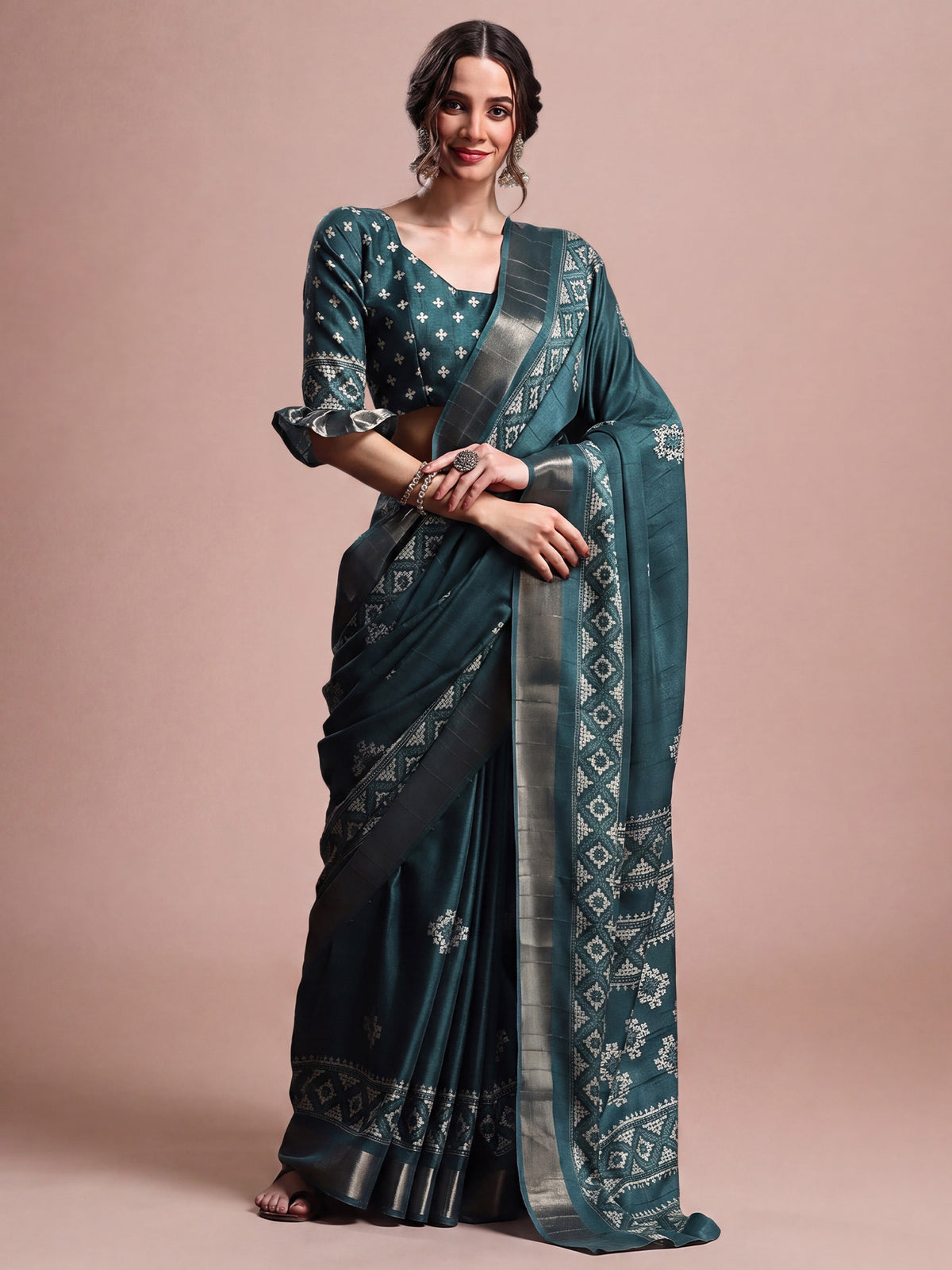 Woman wearing teal blue silk blend saree with geometric pattern design and teal blue blouse