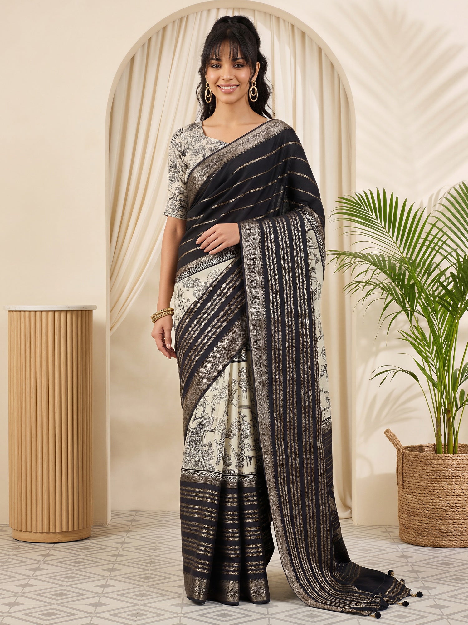 Woman wearing black viscose silk saree with botanical floral and leaf design and off white blouse