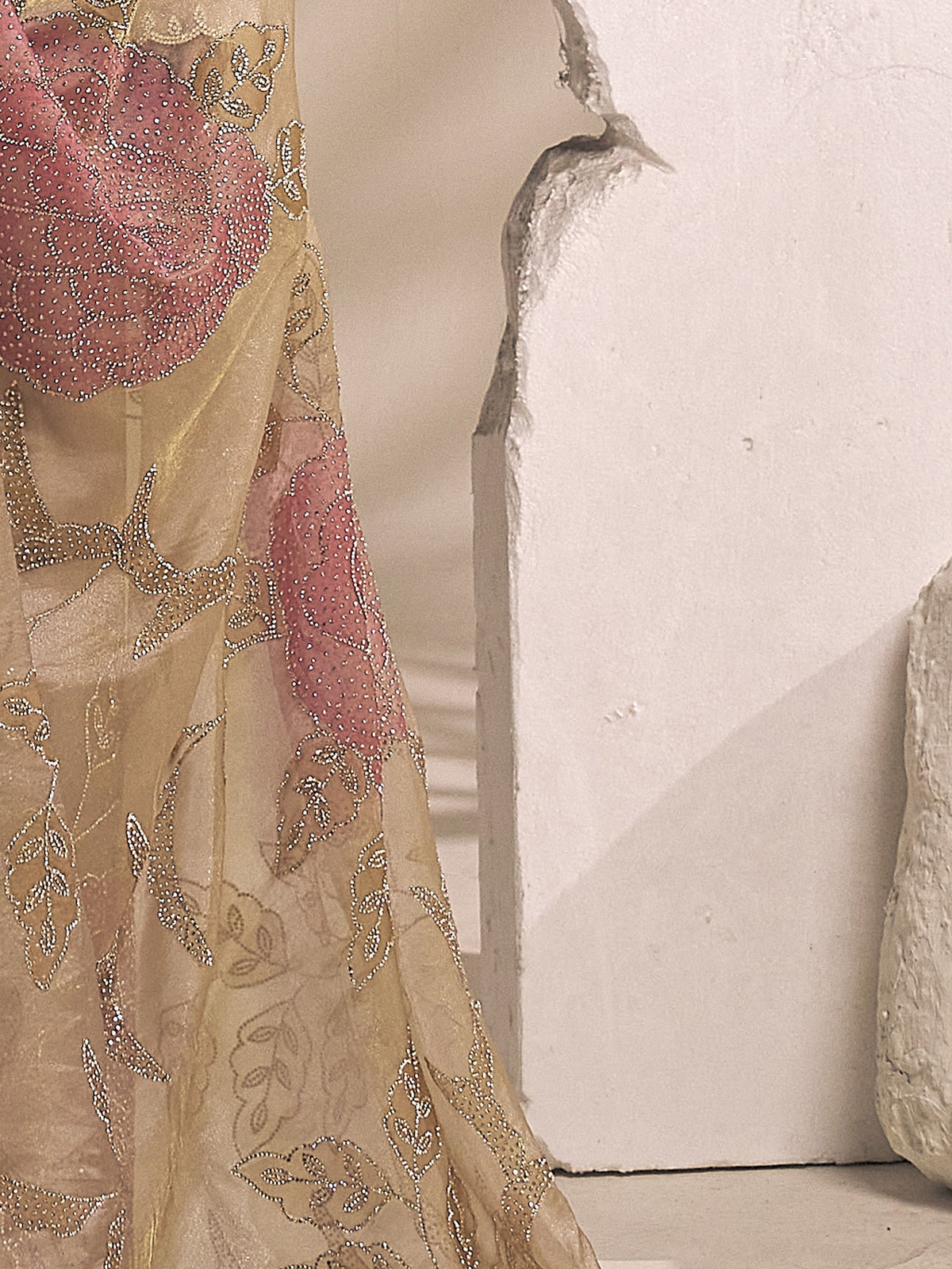 Pallu detail of champagne organza saree showing ornamented surface design and scallop border
