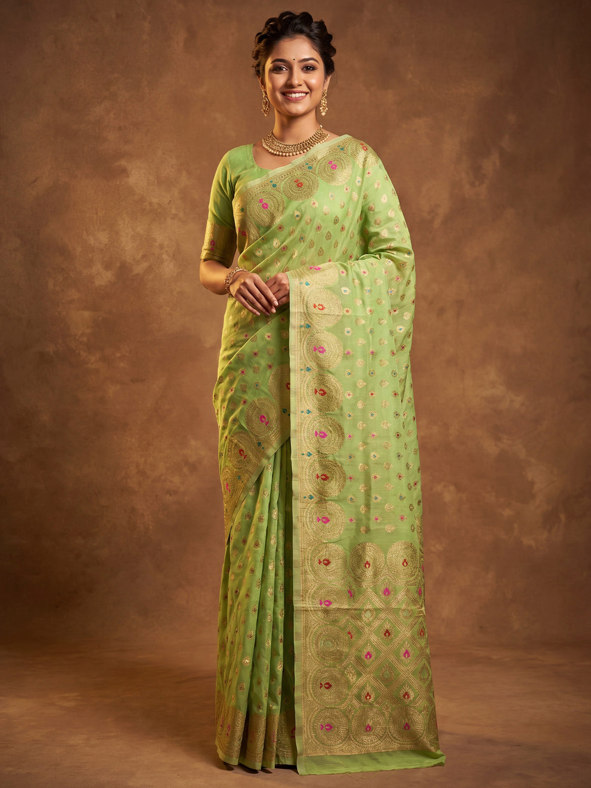 Woman wearing sea green silk blend saree with zari butta (metallic motif) work and sea green blouse