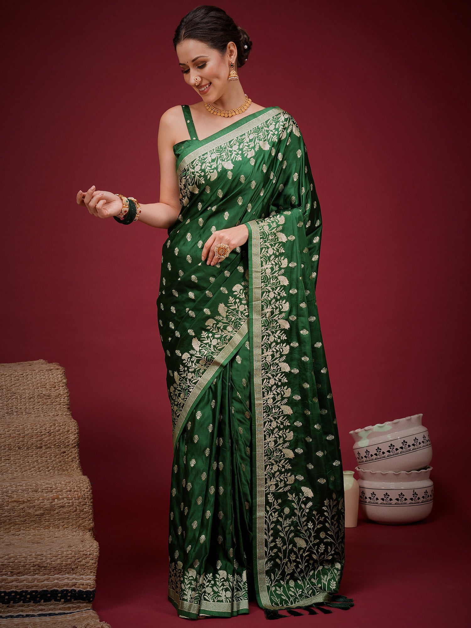 Woman wearing green silk blend saree with zari butta (metallic motif) work and green blouse