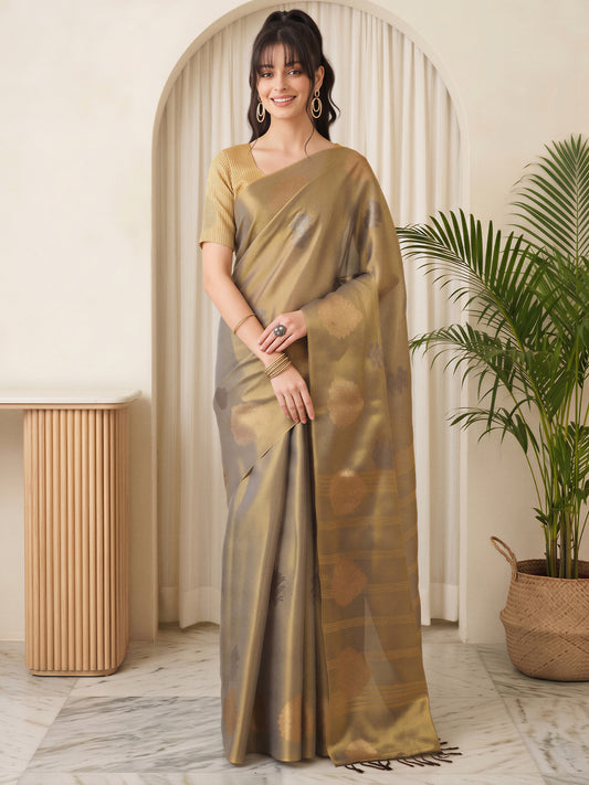 Woman wearing gold linen saree with traditional indian motif work and gold blouse
