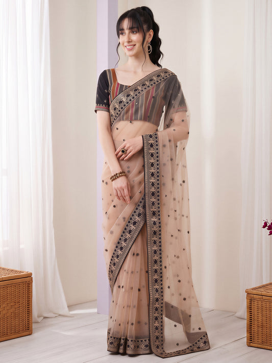 Woman wearing beige net saree with embroidered motif work and black blouse