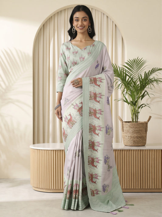 Woman wearing lavender silk blend saree with traditional indian motif work and light green blouse