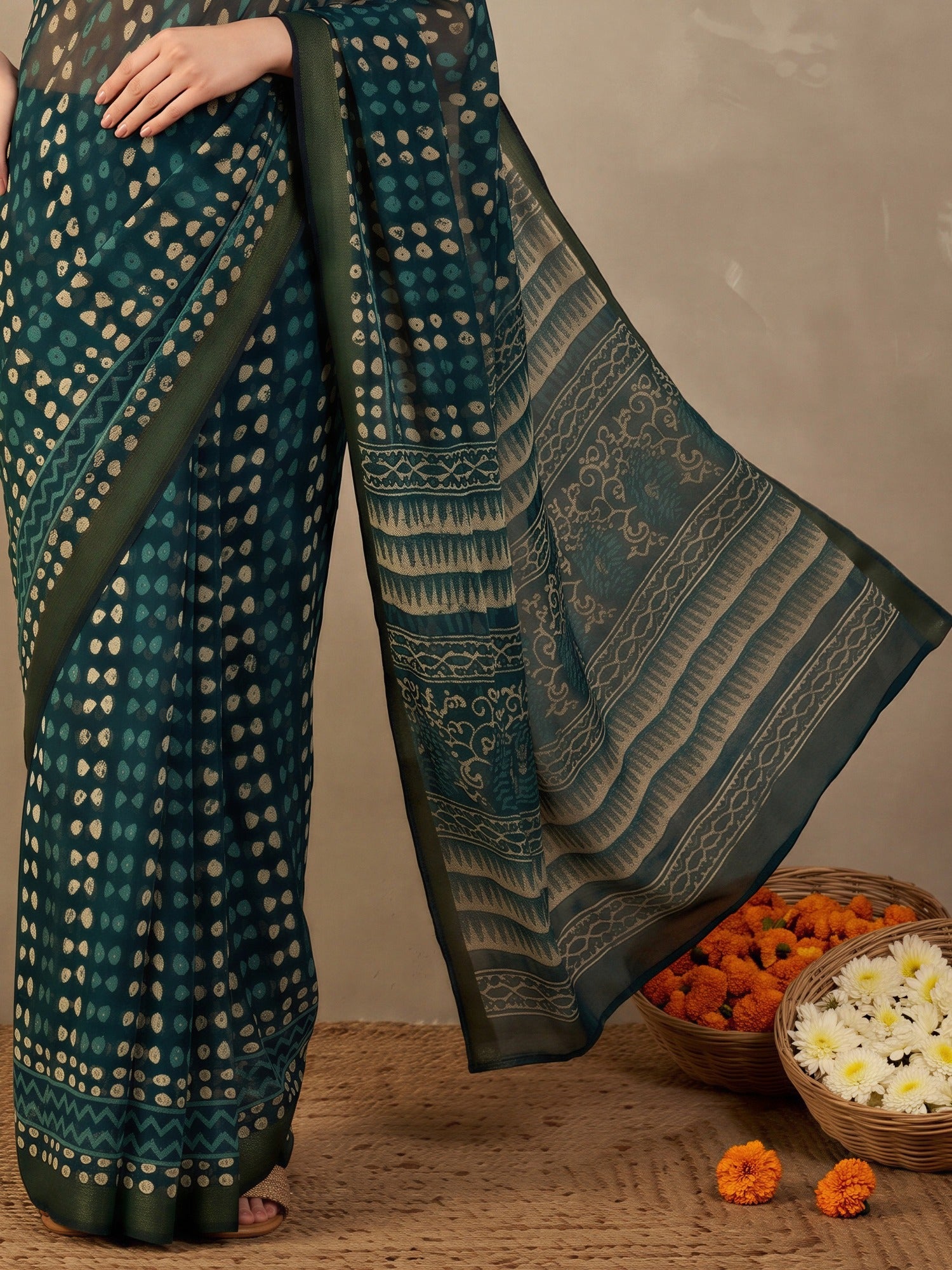 Pallu detail of teal blue cotton linen saree showing traditional indian motif work and zari border
