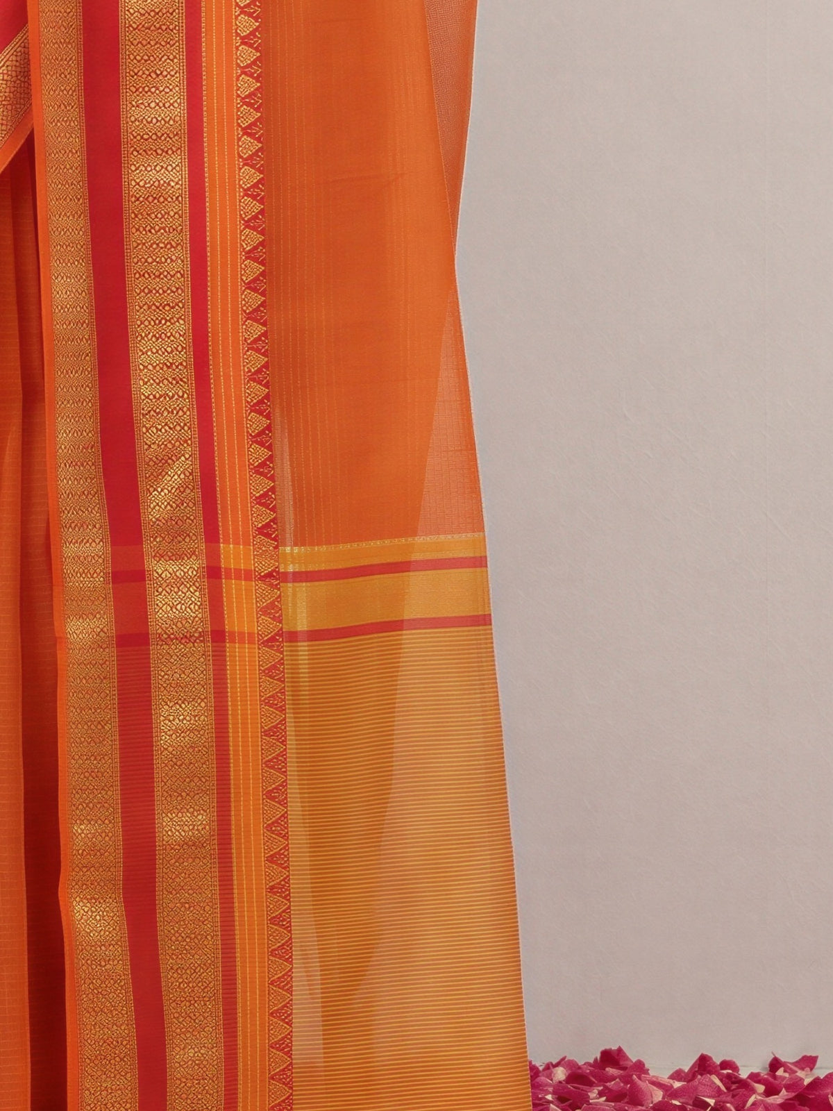 Pallu detail of orange kota doria cotton saree showing clean solid-tone finish and zari border