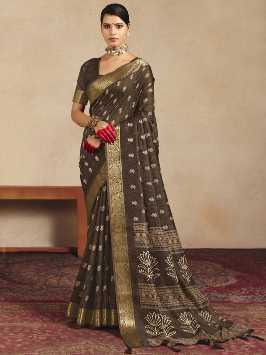 Woman wearing brown tussar silk saree with traditional indian motif work and brown blouse
