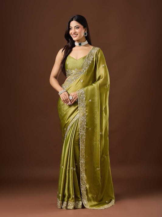 Woman wearing olive chinnon saree with embroidered motif work and olive blouse