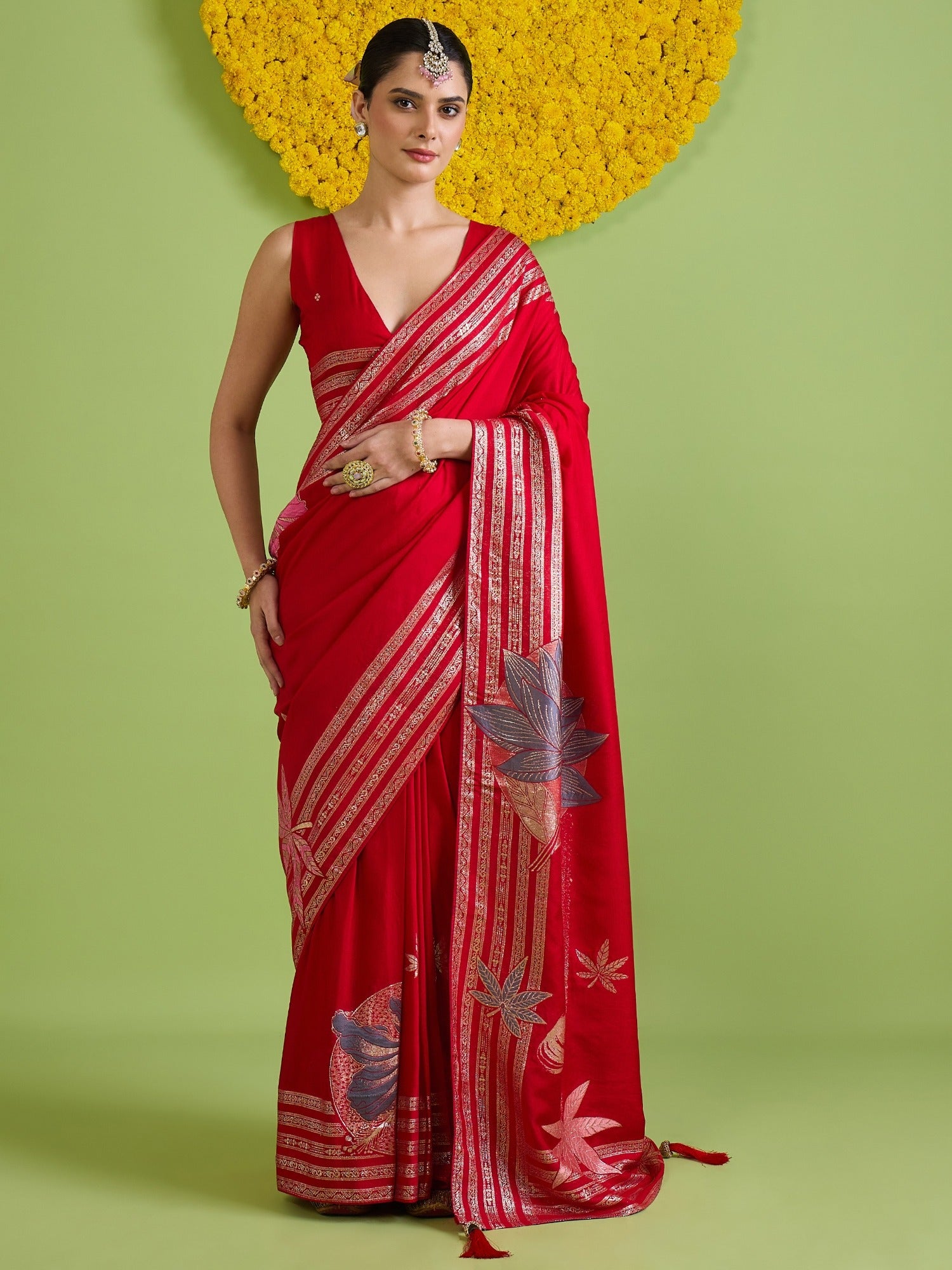 Woman wearing red silk blend saree with woven motif design and red blouse