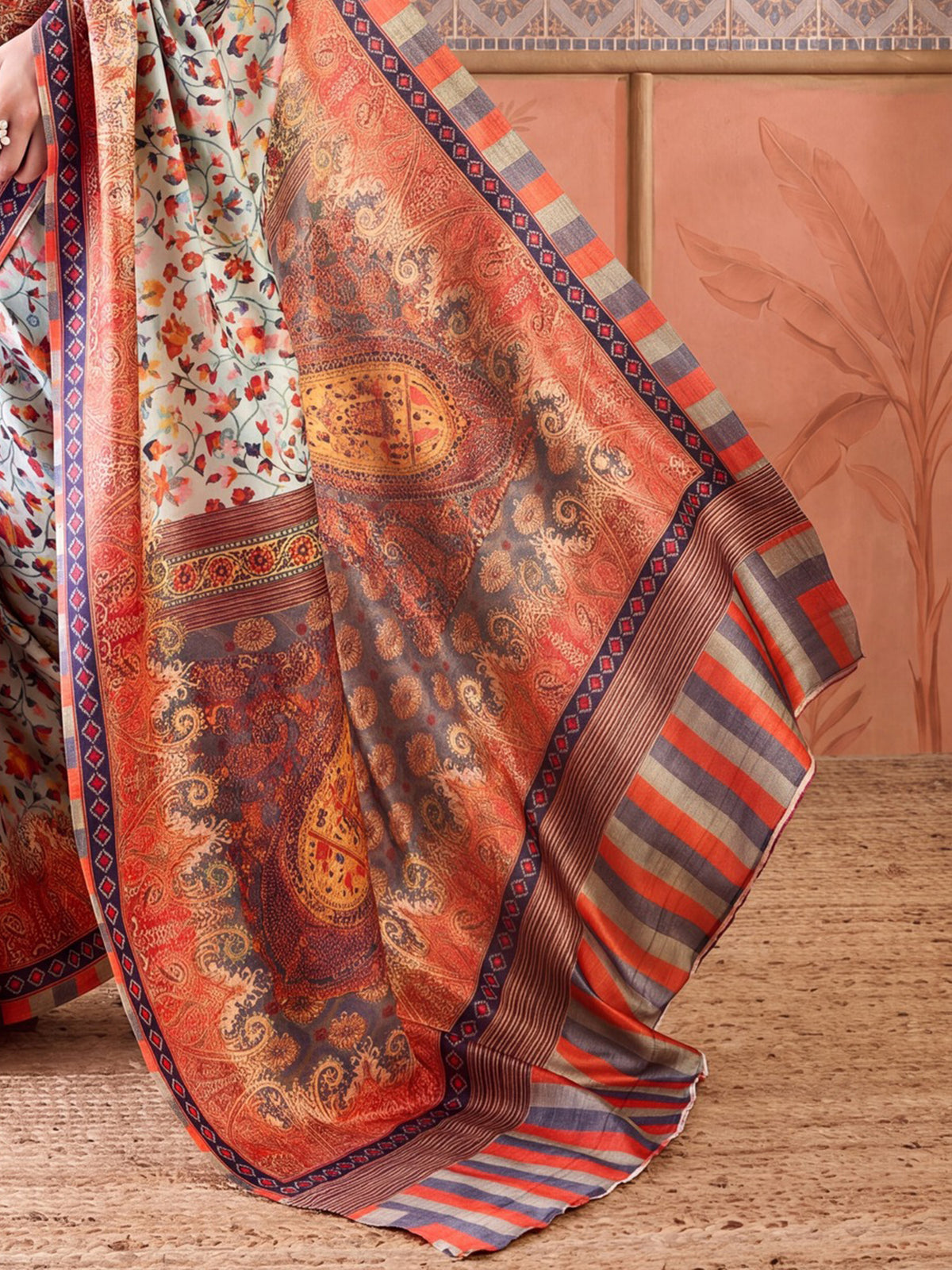 Pallu detail of sea green poly silk saree showing paisley (kairi) motif work and printed border