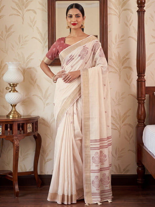 Woman wearing white satin silk saree with traditional indian motif work and mauve blouse