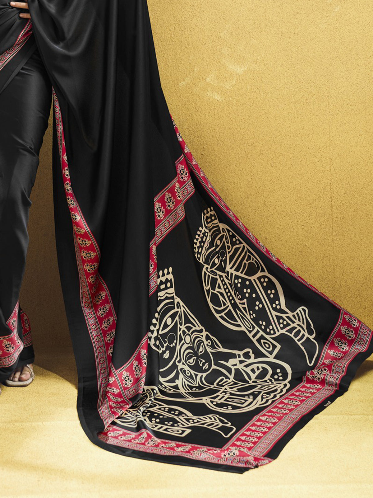 Pallu detail of black satin saree showing ajrak block-print motif work and printed border