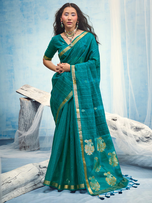 Woman wearing teal blue muga silk saree with zari butta (metallic motif) work and teal blue blouse