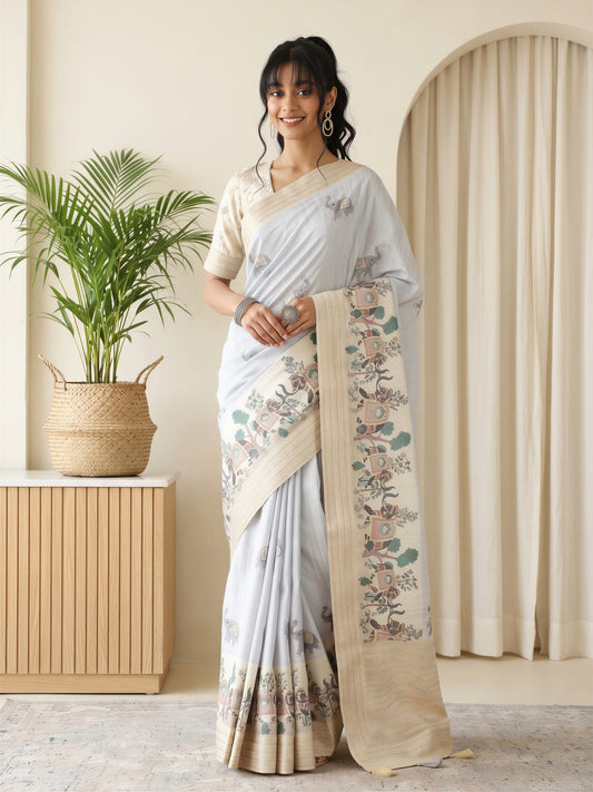 Woman wearing grey silk blend saree with traditional indian motif work and beige blouse