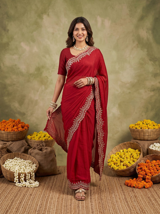 Woman wearing red satin silk saree with embroidered motif work and red blouse
