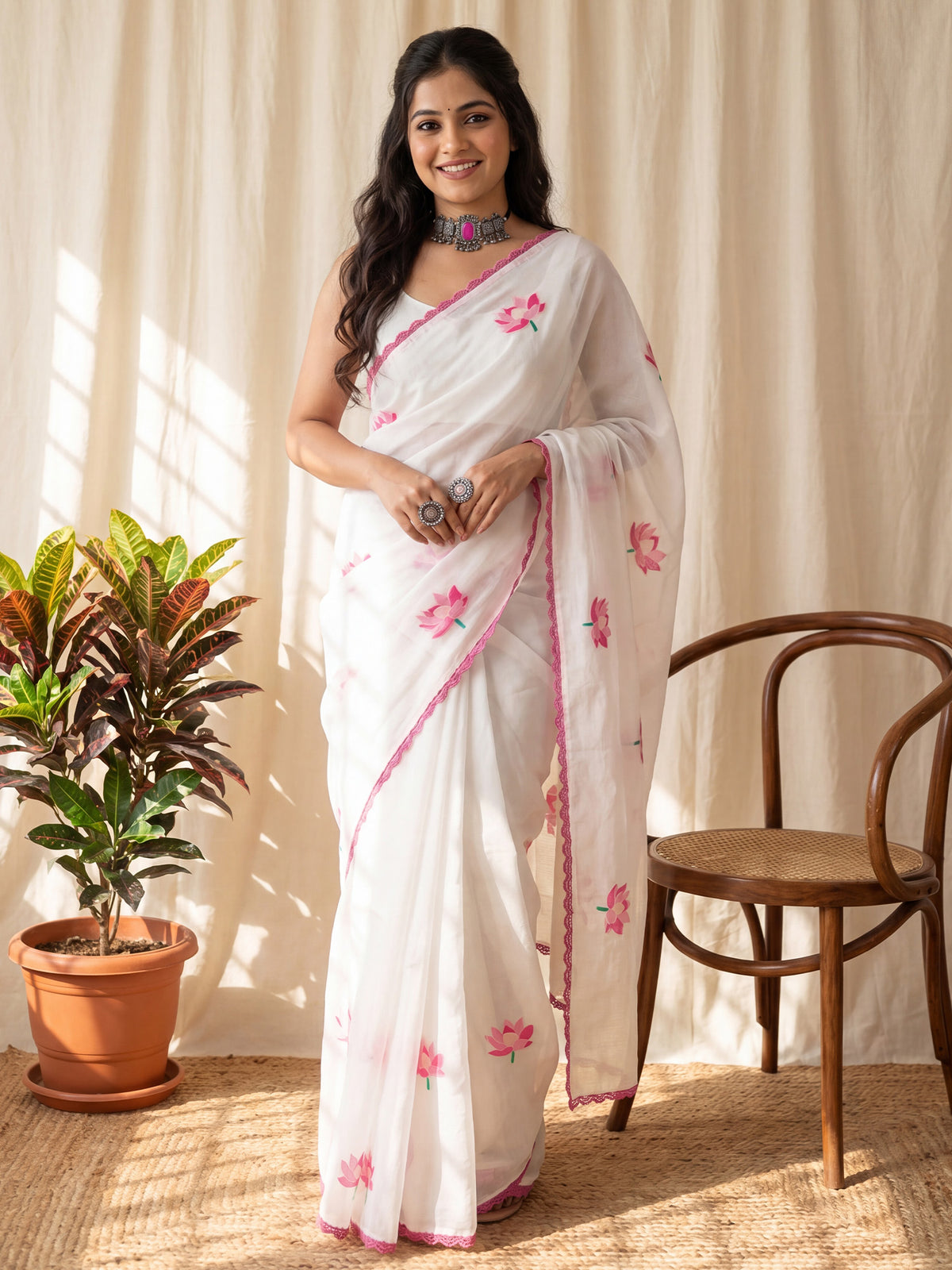 Woman wearing white chanderi cotton saree with all-over floral design and white blouse