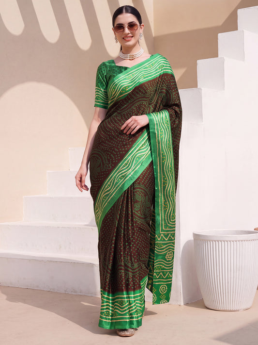 Woman wearing brown satin silk saree with bandhani tie-dye dot work and green blouse