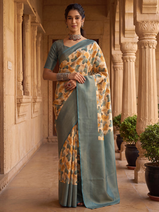 Woman wearing cream silk blend saree with all-over floral design and light blue blouse