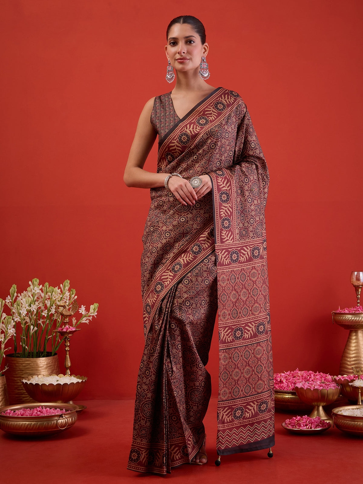 Woman wearing maroon silk blend ready to wear saree with ajrak block-print motif work and black blouse