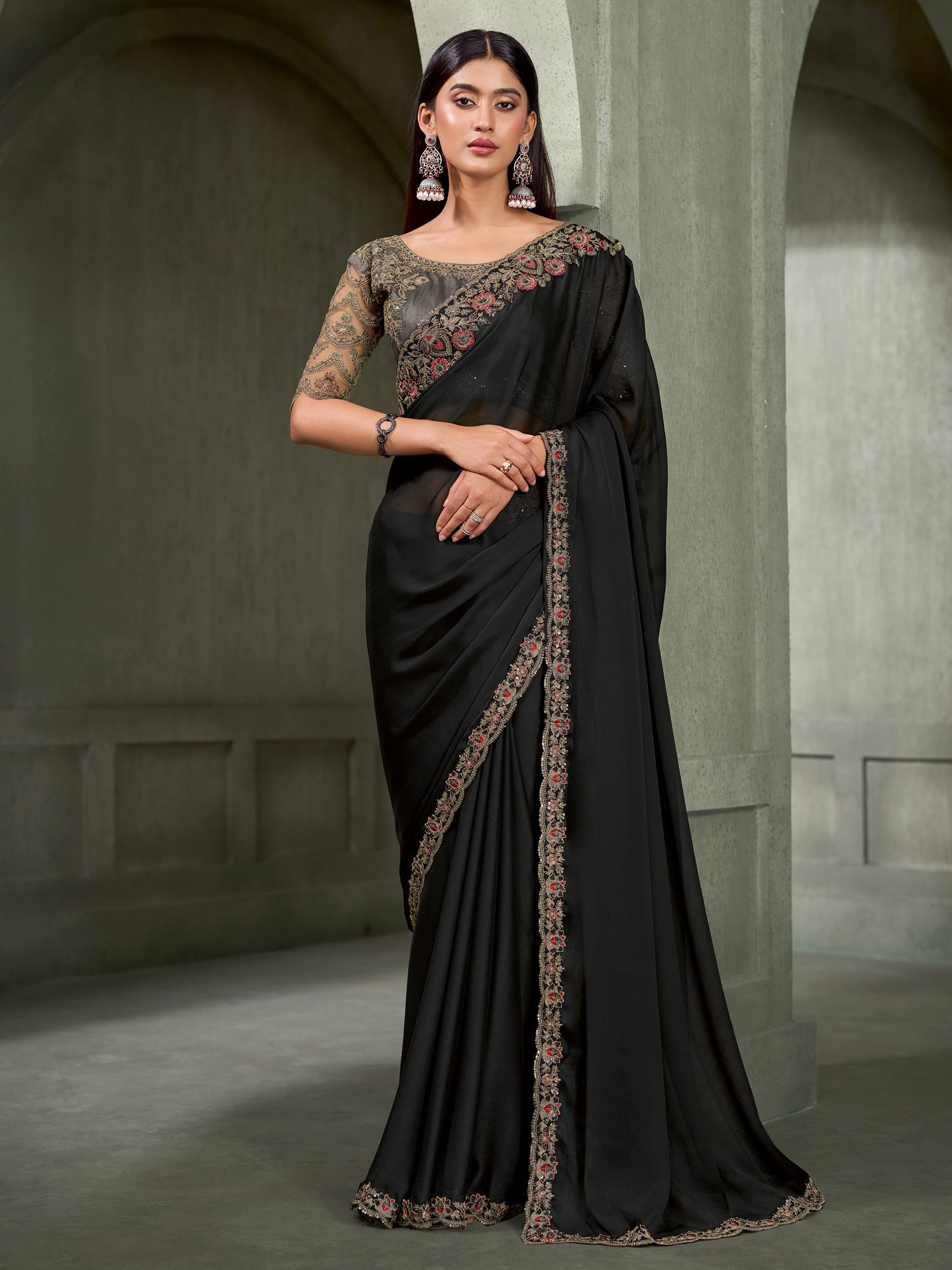 Woman wearing black chiffon saree with embroidered motif work and charcoal grey blouse