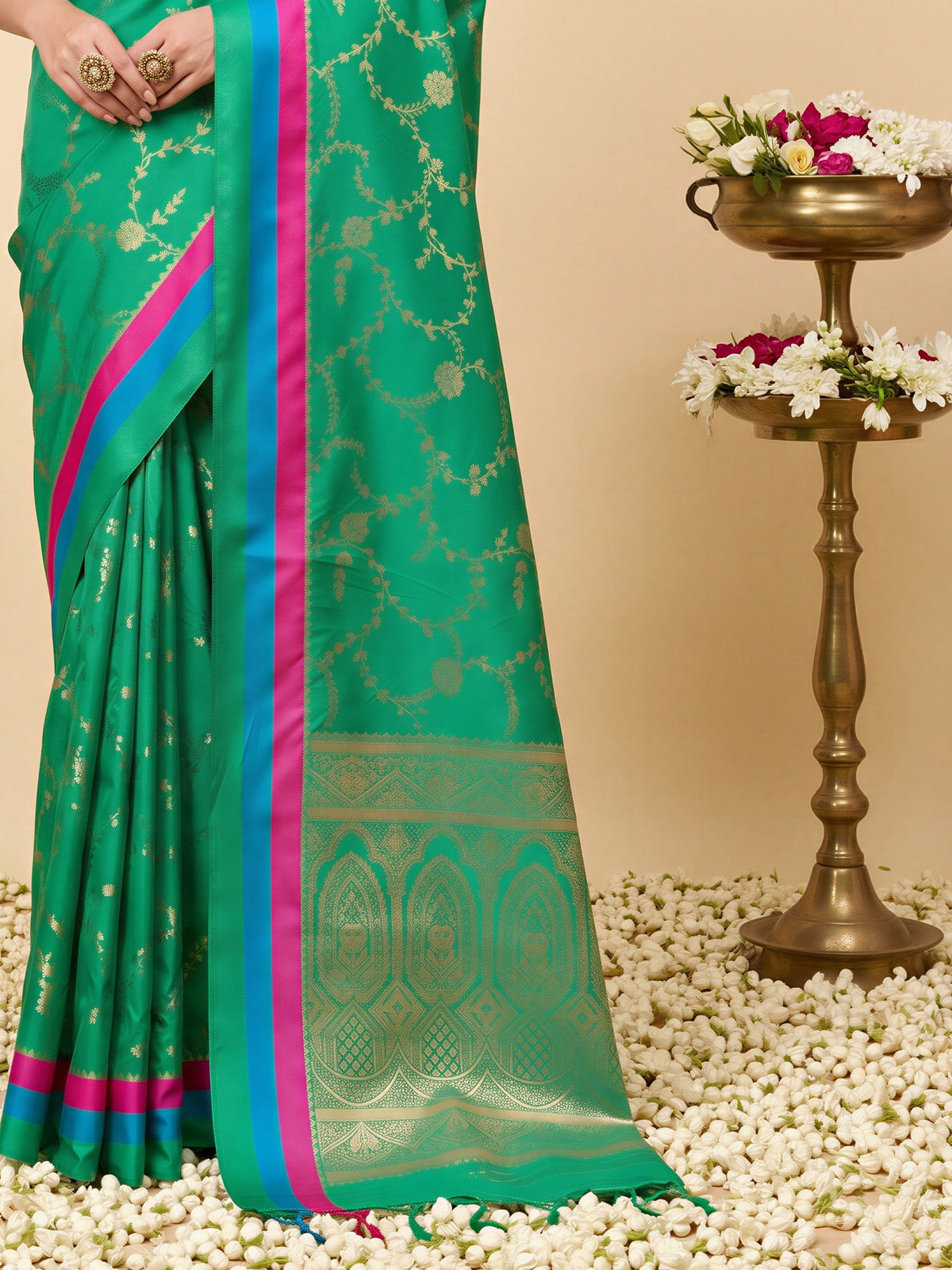 Pallu detail of teal green pure silk saree showing traditional indian motif work and zari border