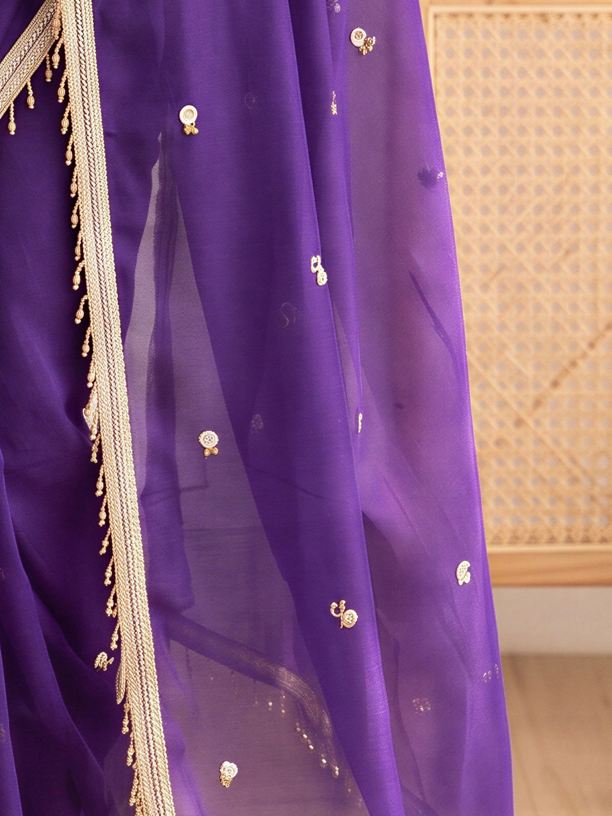 Pallu detail of purple poly georgette saree showing ornamented surface design and embellished border