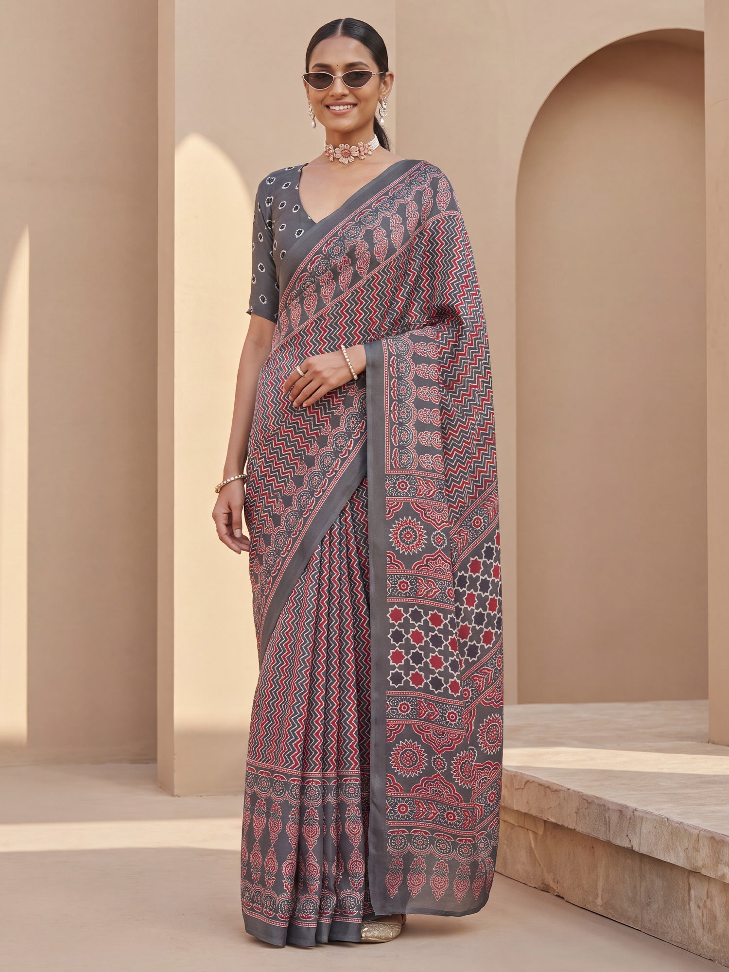 Woman wearing grey satin saree with geometric pattern design and grey blouse