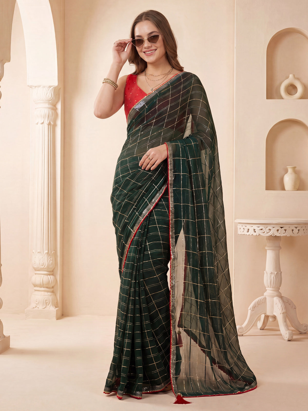 Woman wearing dark green viscose saree with checkered design and red blouse