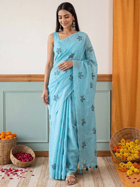 Woman wearing light blue kota doria cotton saree with embroidered motif work and light blue blouse