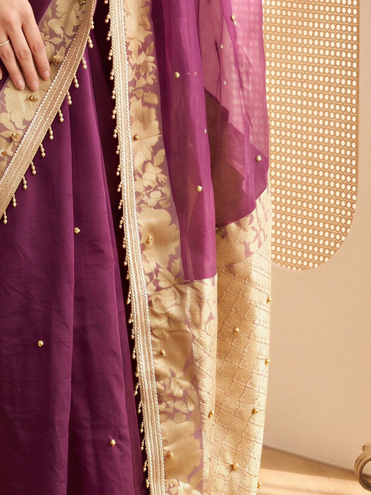 Pallu detail of wine silk blend saree showing traditional indian motif work and zari border