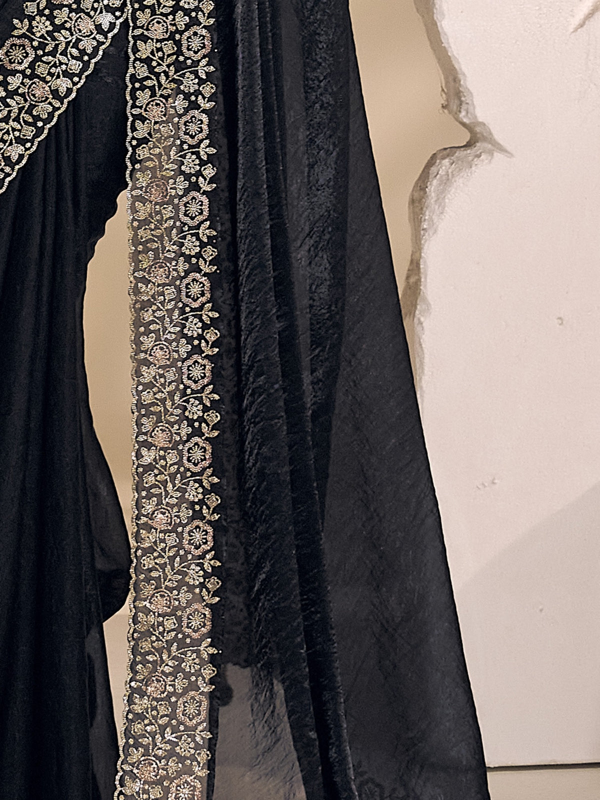 Pallu detail of black satin silk saree showing clean solid-tone finish and embellished border