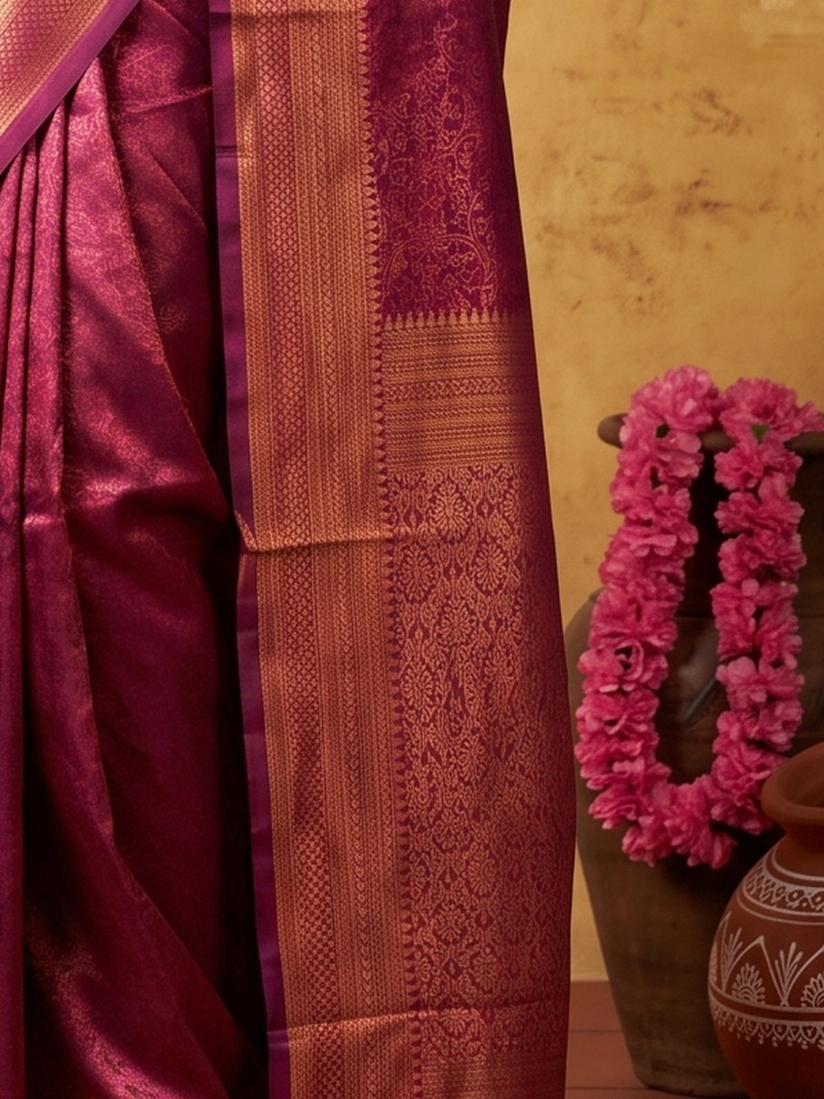 Pallu detail of wine silk blend saree showing traditional indian motif work and zari border