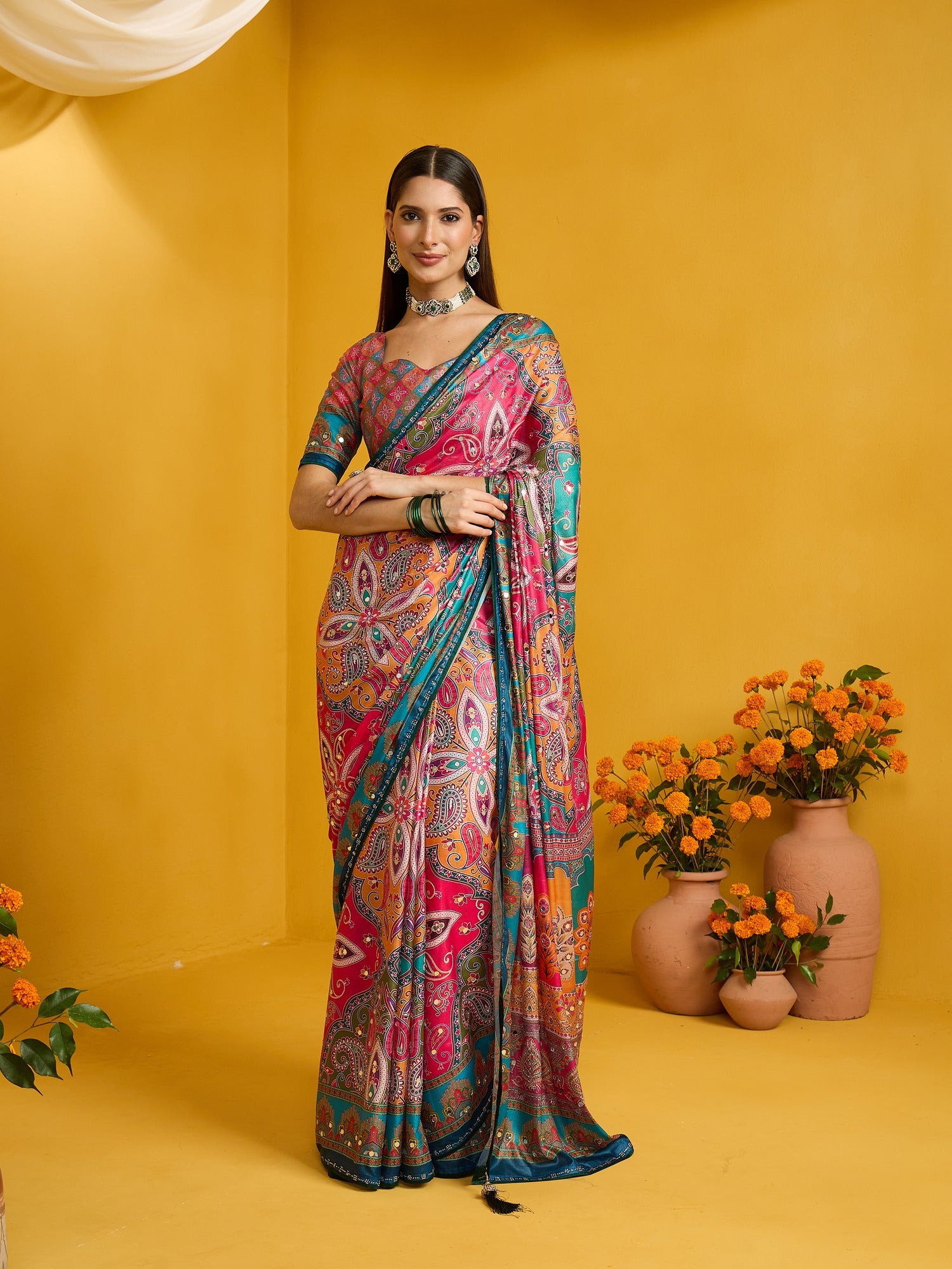 Woman wearing pink silk blend saree with ornamented surface design and multicolored blouse