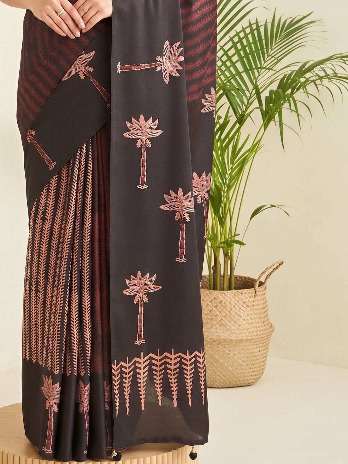 Pallu detail of black silk blend saree showing traditional indian motif work and printed border