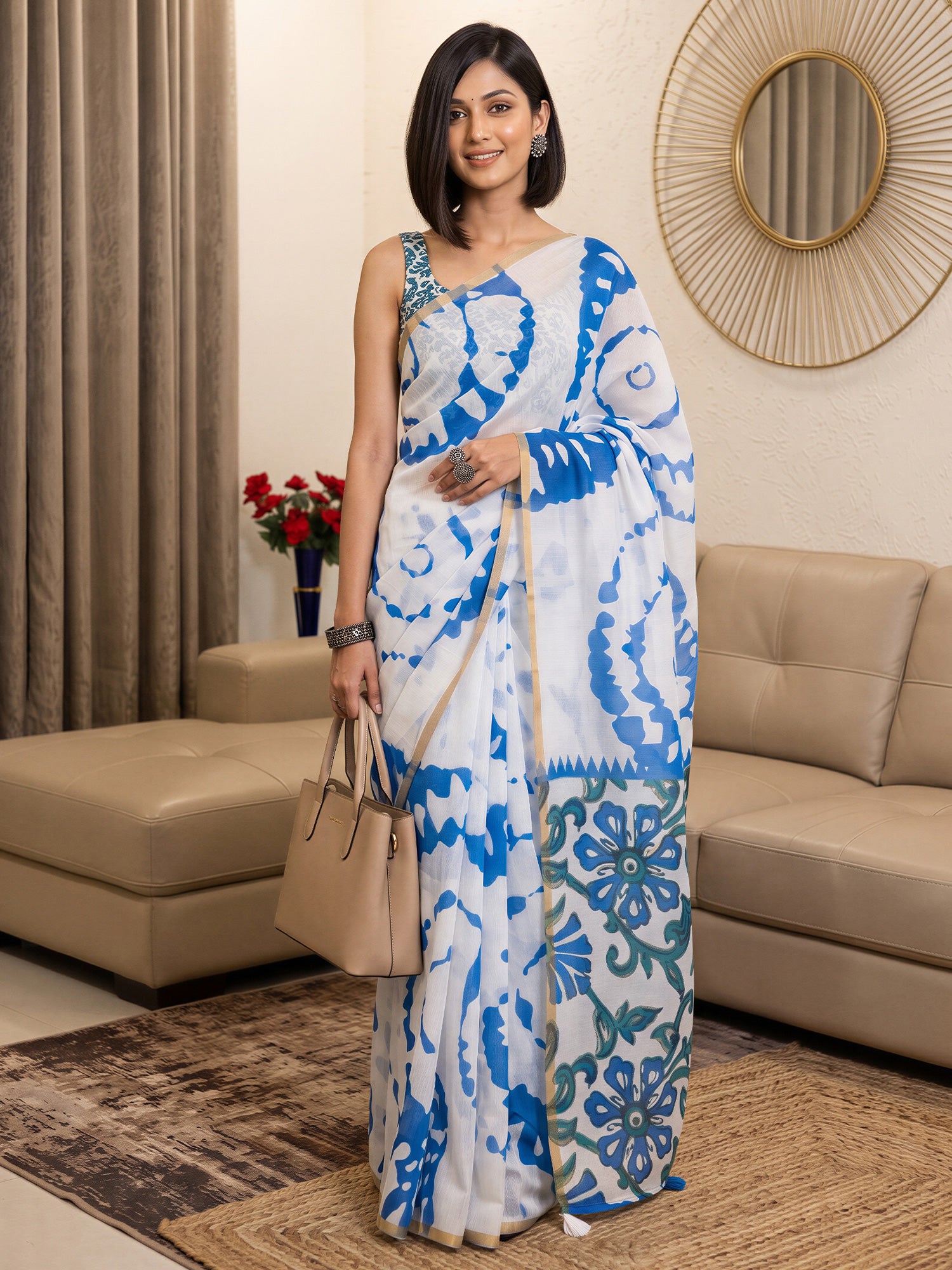 Woman wearing white cotton blend saree with shibori resist-dye pattern and teal blue blouse