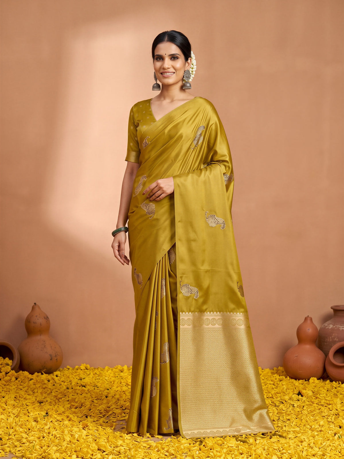 Woman wearing mustard satin silk saree with animal-print design and mustard blouse