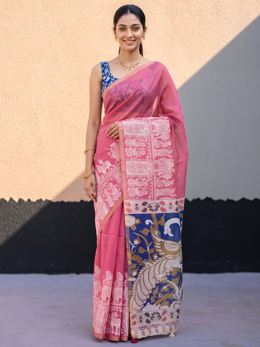 Woman wearing pink cotton blend saree with kalamkari narrative motif work and blue blouse