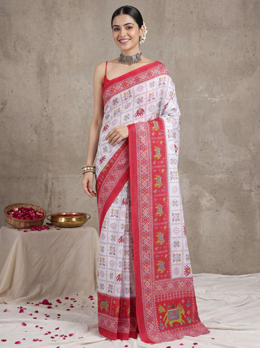 Woman wearing white cotton saree with traditional indian motif work and pink blouse