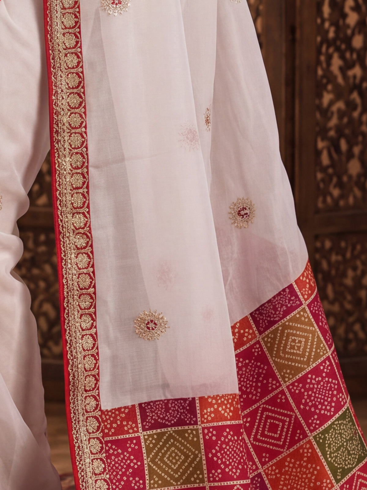 Pallu detail of white viscose saree showing ornamented surface design and embellished border